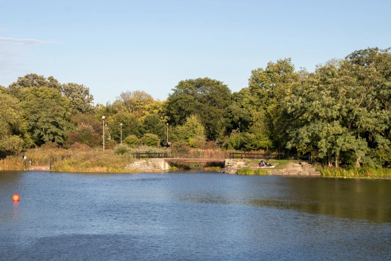 the water is placid with many small trees around it