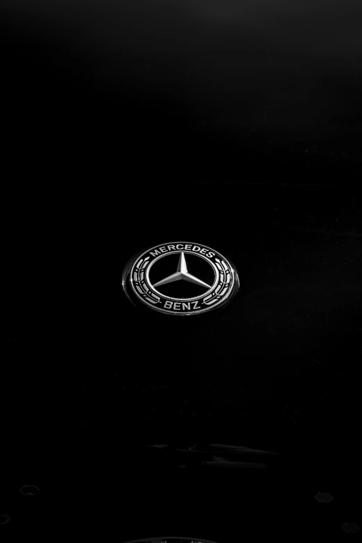 the mercedes logo is shown in black and white