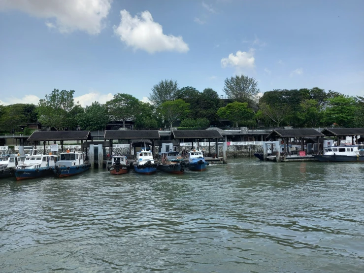 a bunch of boats in some water next to some houses