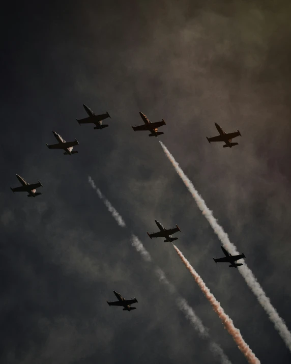 a group of planes flying in formation at night