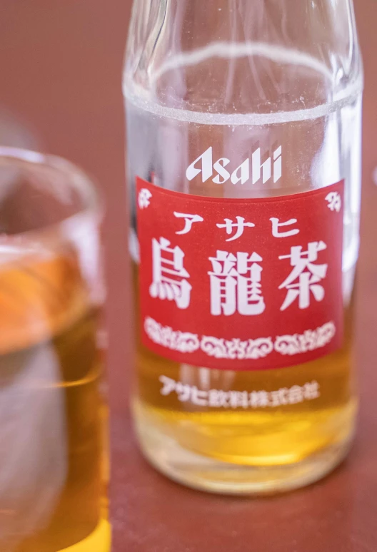 a glass with some tea in it on the table