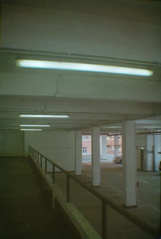 an empty parking space has three white pillars