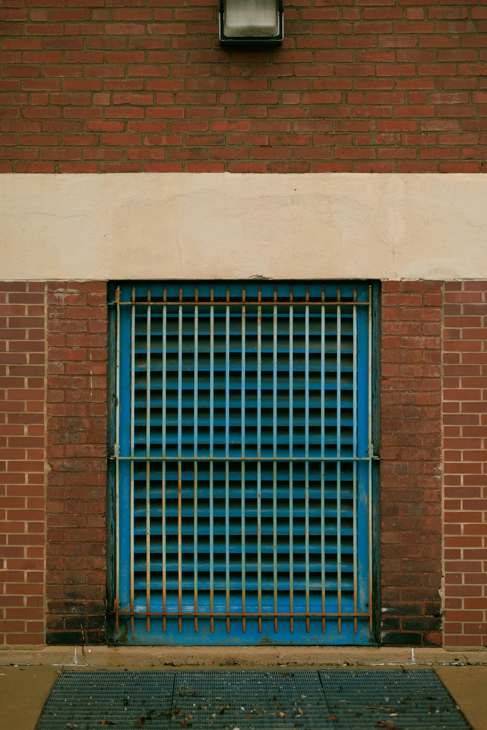 a fire hydrant next to a brick wall with blue glass door