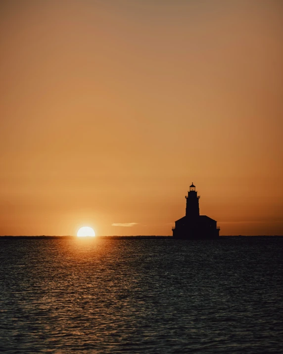 a lighthouse in the distance near a body of water