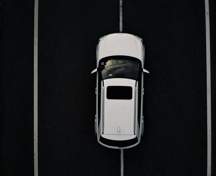 an aerial s of a car on the road