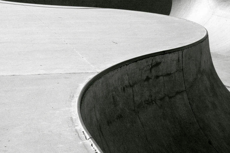 a boy is skateboarding on a concrete ramp