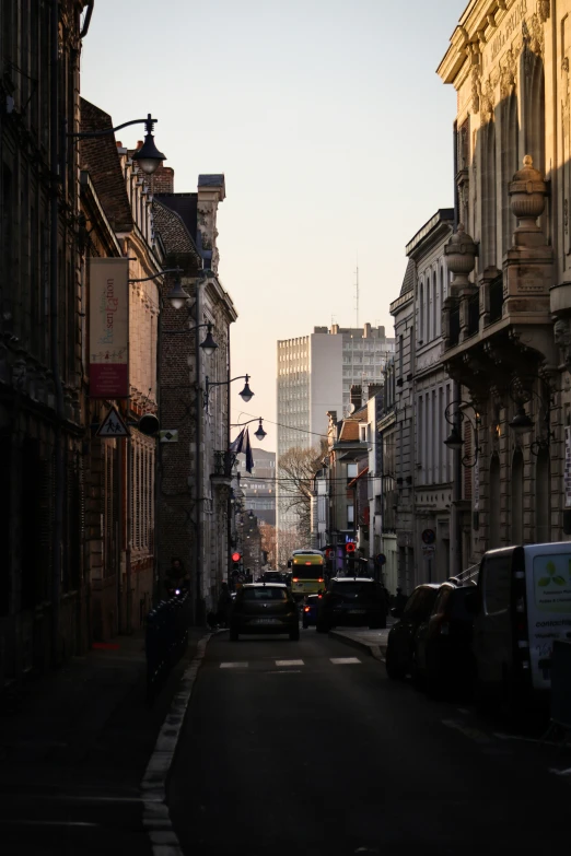 a couple of cars are driving down a city street