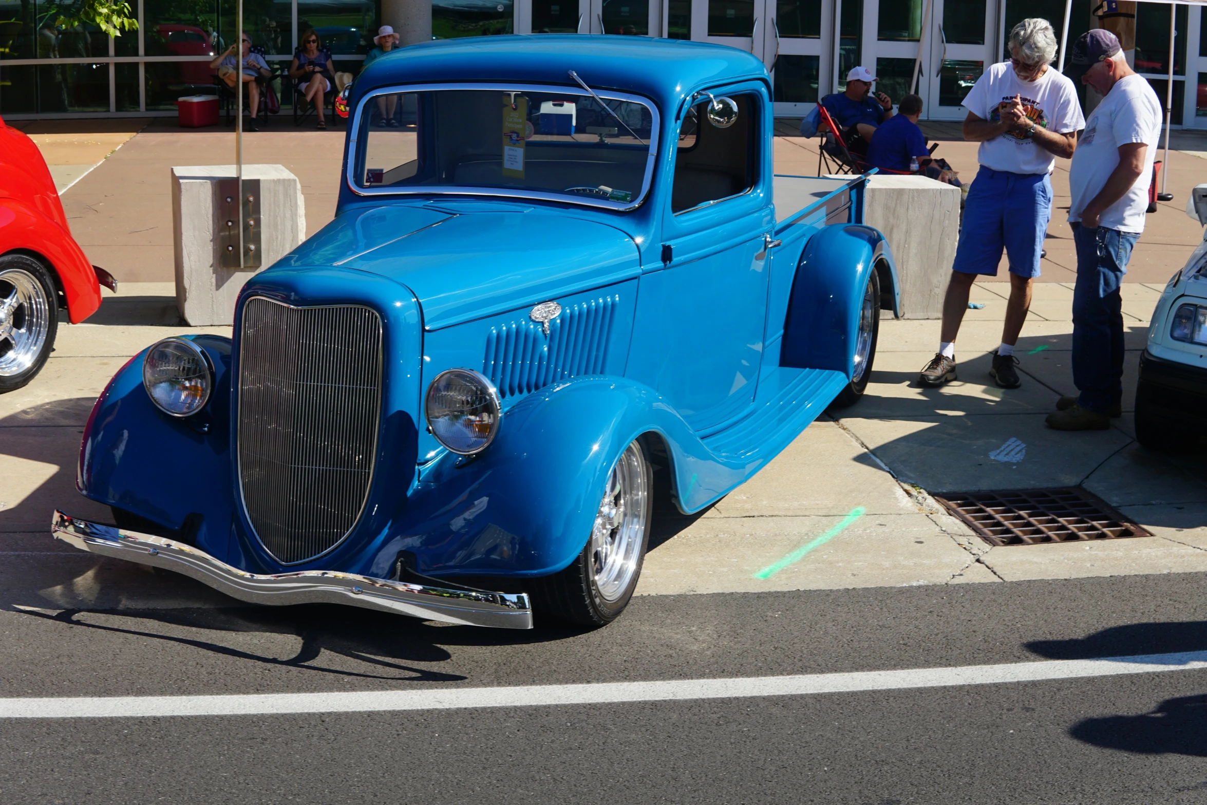 an antique pickup parked on the side of a road