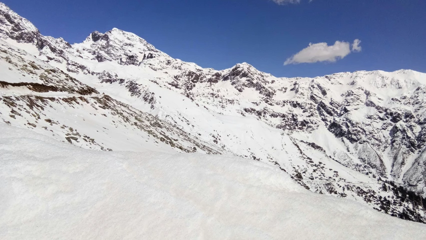 a man riding a snowboard down the side of a mountain