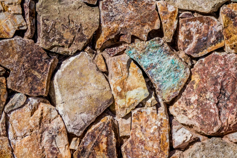 a variety of brown and white rocks with colored paint