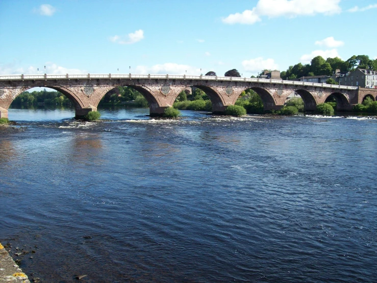 a bridge that goes over the water that is very close to the shore