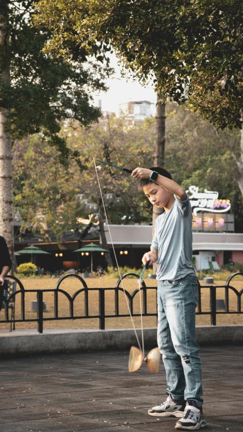 a person holding soing while standing on a street