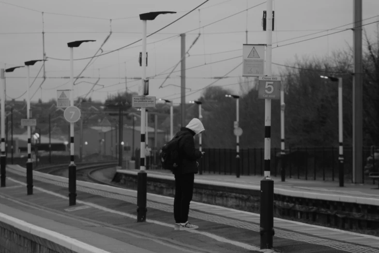 the person is waiting for the train at the station