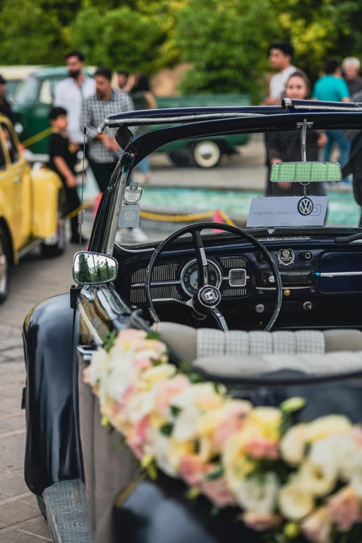 a man drives his old car in a parade