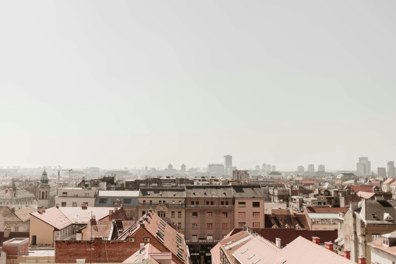 the city view shows roofs with small brown buildings