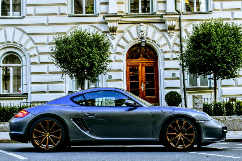 the grey sports car is parked on the street