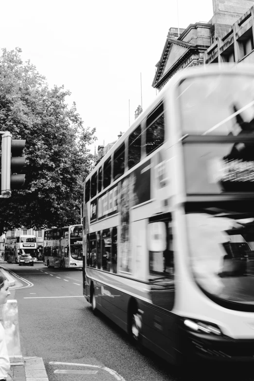 a double decker bus passes by a pedestrian crossing