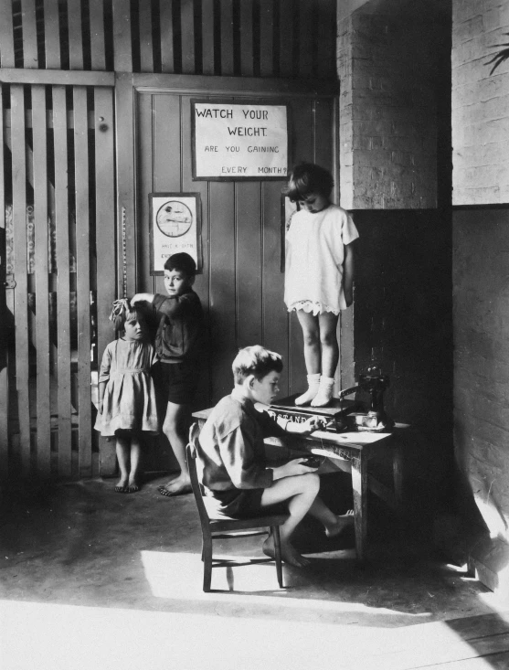 an old black and white po of a group of children standing around