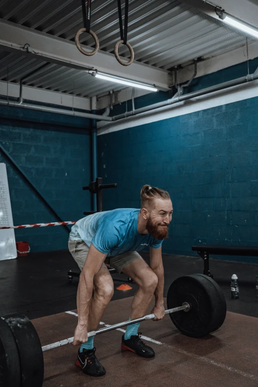 a man squats while holding the barbell