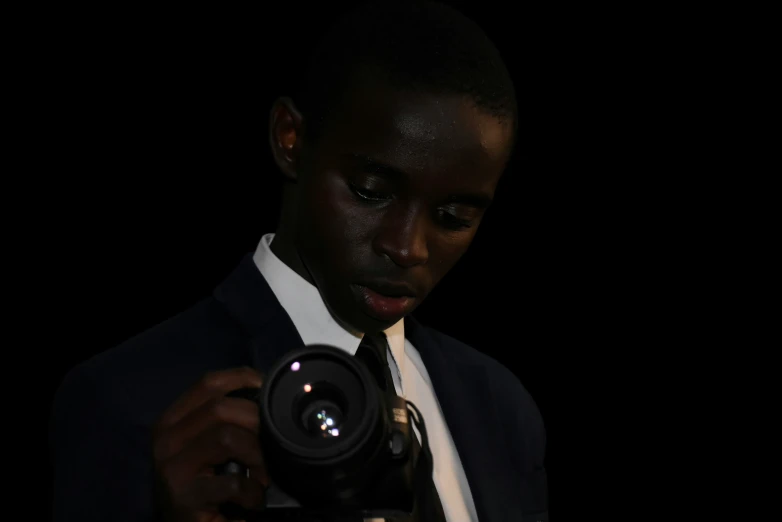 a man in a suit and tie holding a camera