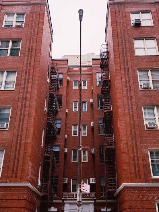red brick apartment building with staircase to the second floor