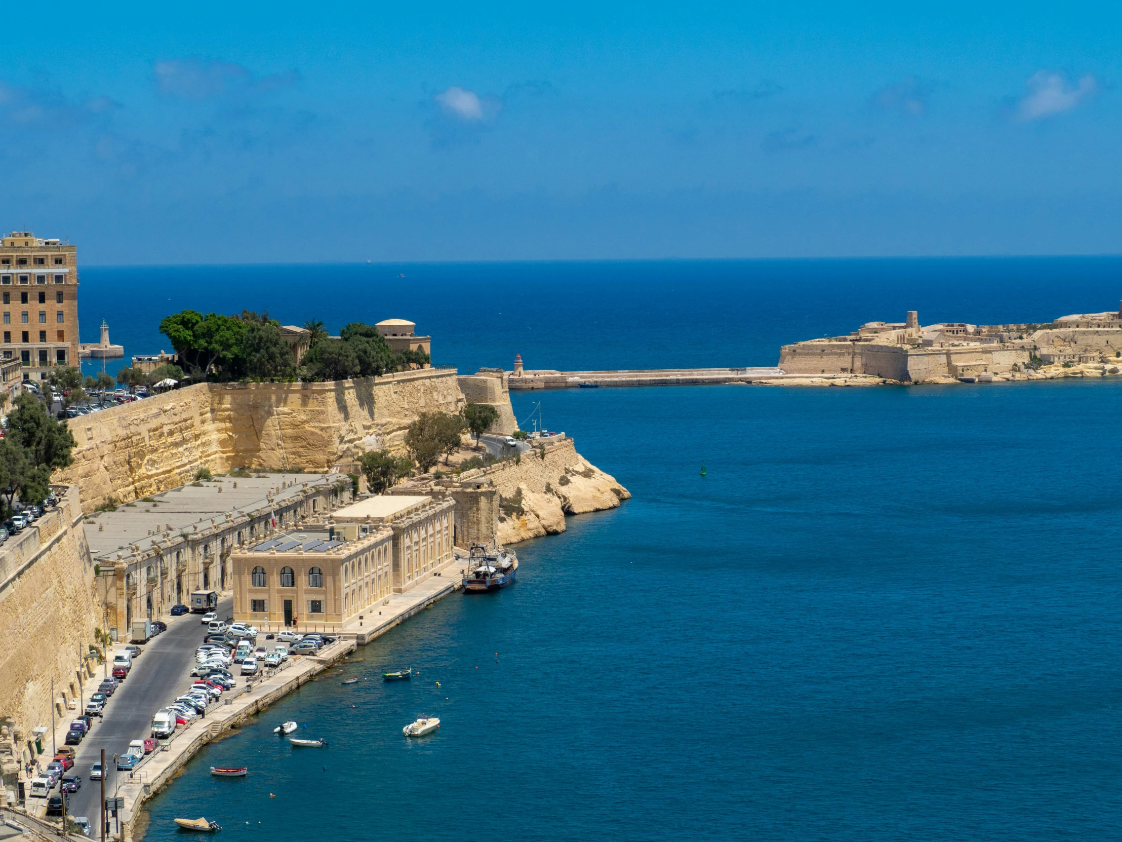 the water and city walls are blue with some buildings on it