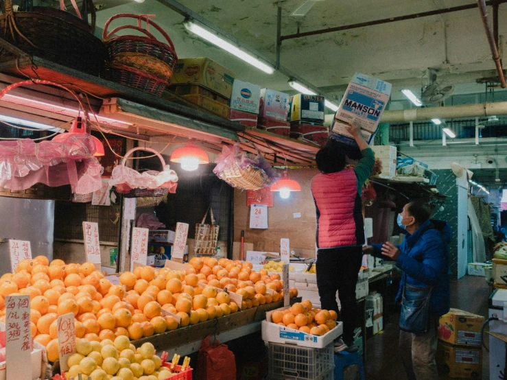 two women shopping at a fruit stand in the country