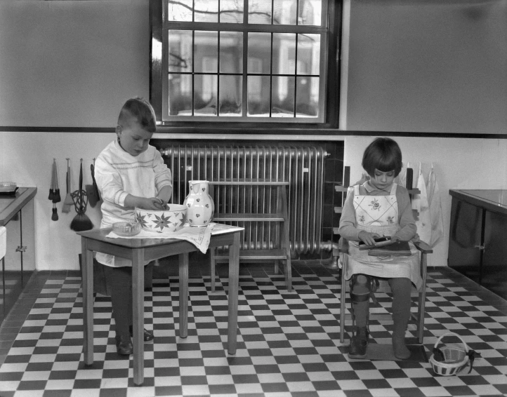 two children play with their toys in a kitchen