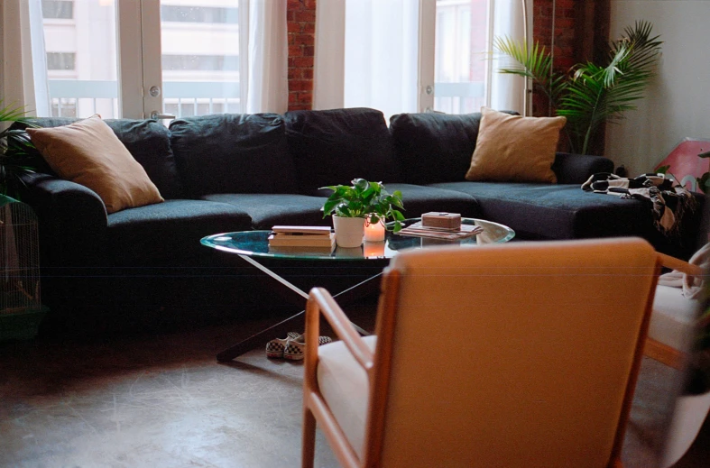 a couch sitting in a living room next to a chair