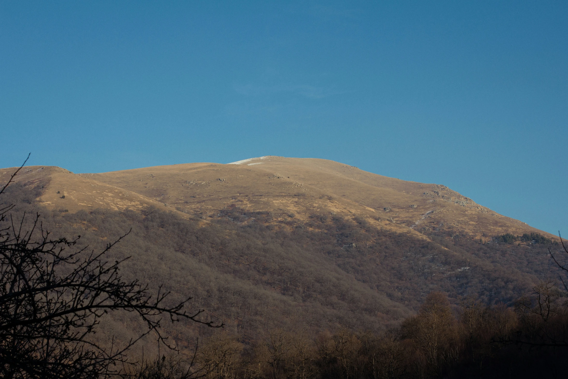 a large hill with a white snow capped top