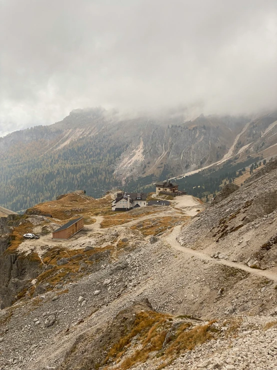 a road through the mountains covered in rocks and gravel