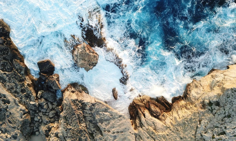 an aerial s of the ocean and cliffs