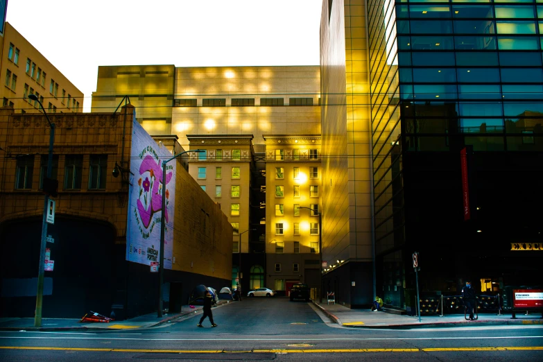 the people are crossing the cross walk in a big city