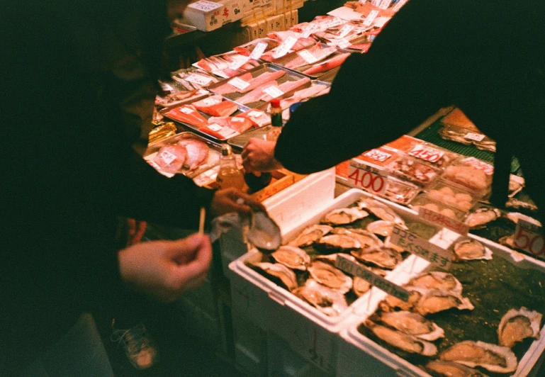 people are standing in front of some fish