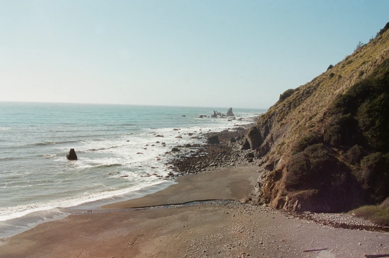 there is a person walking down the beach