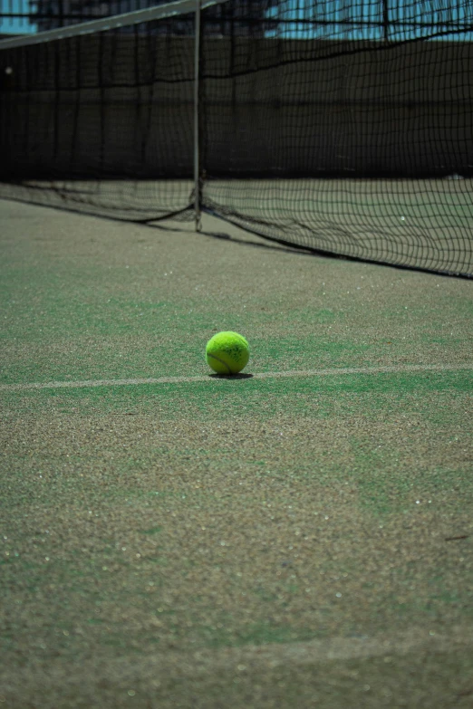 a tennis ball on a court near the net