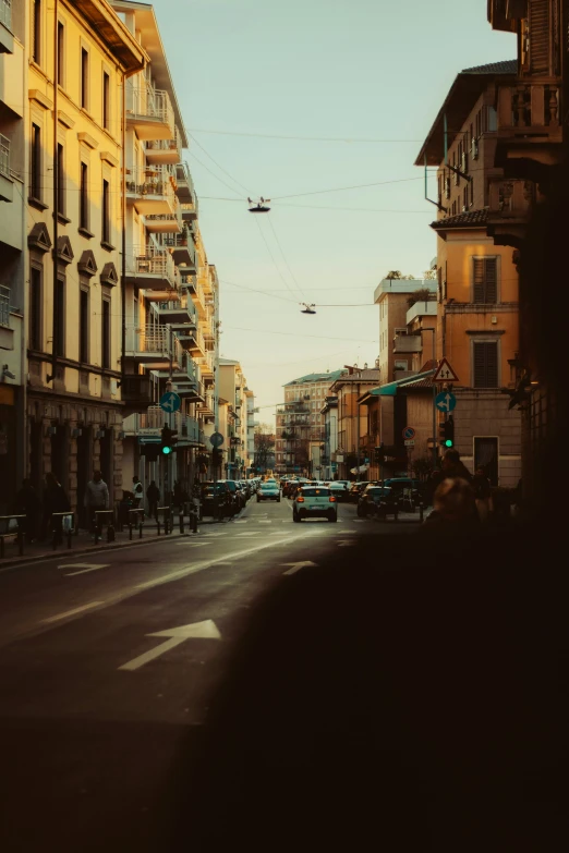 a city street filled with traffic next to tall buildings