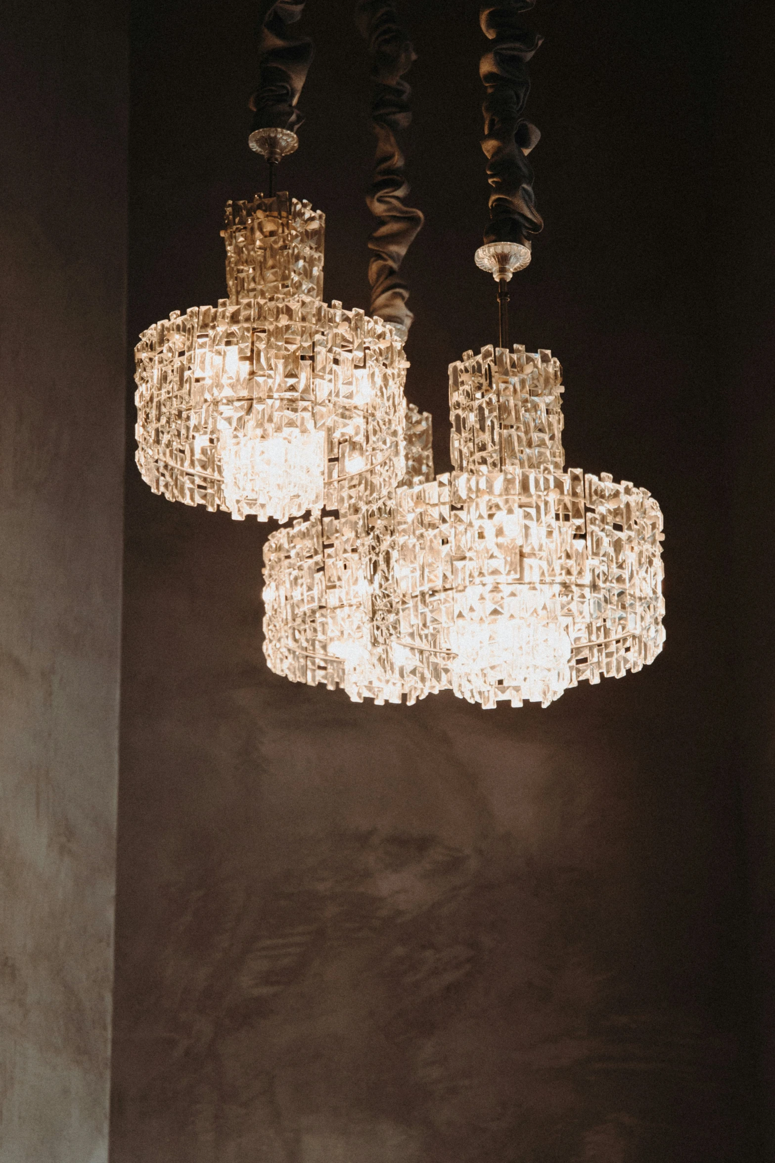 a chandelier hangs from a ceiling over a table