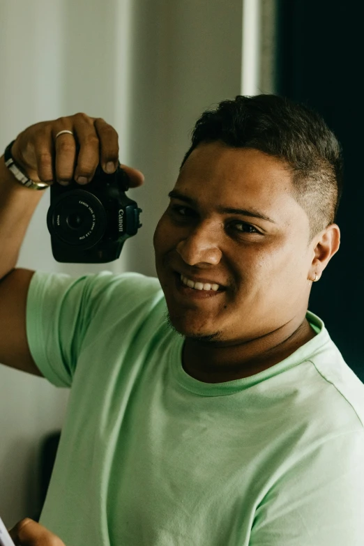 a young man taking a picture with a digital camera