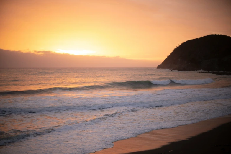 the sun is setting over the water and it looks like a wave