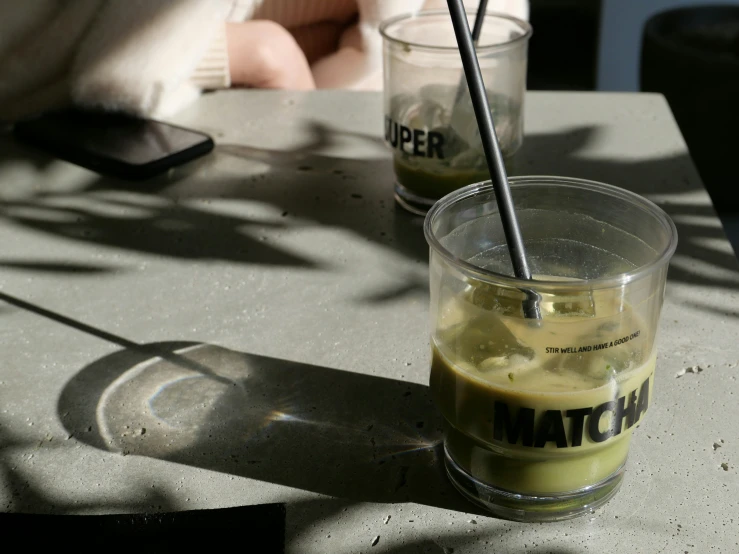 a glass of match on top of a table