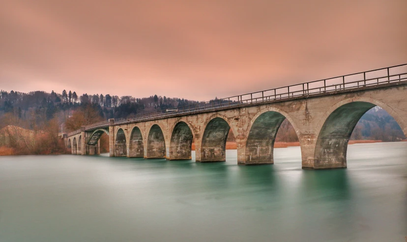 an old train bridge over a lake