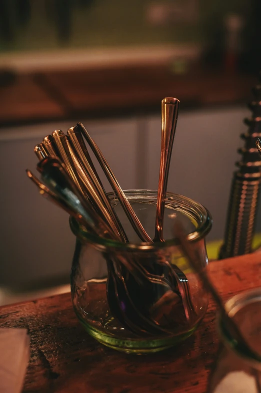 the table has some metal utensils in a glass