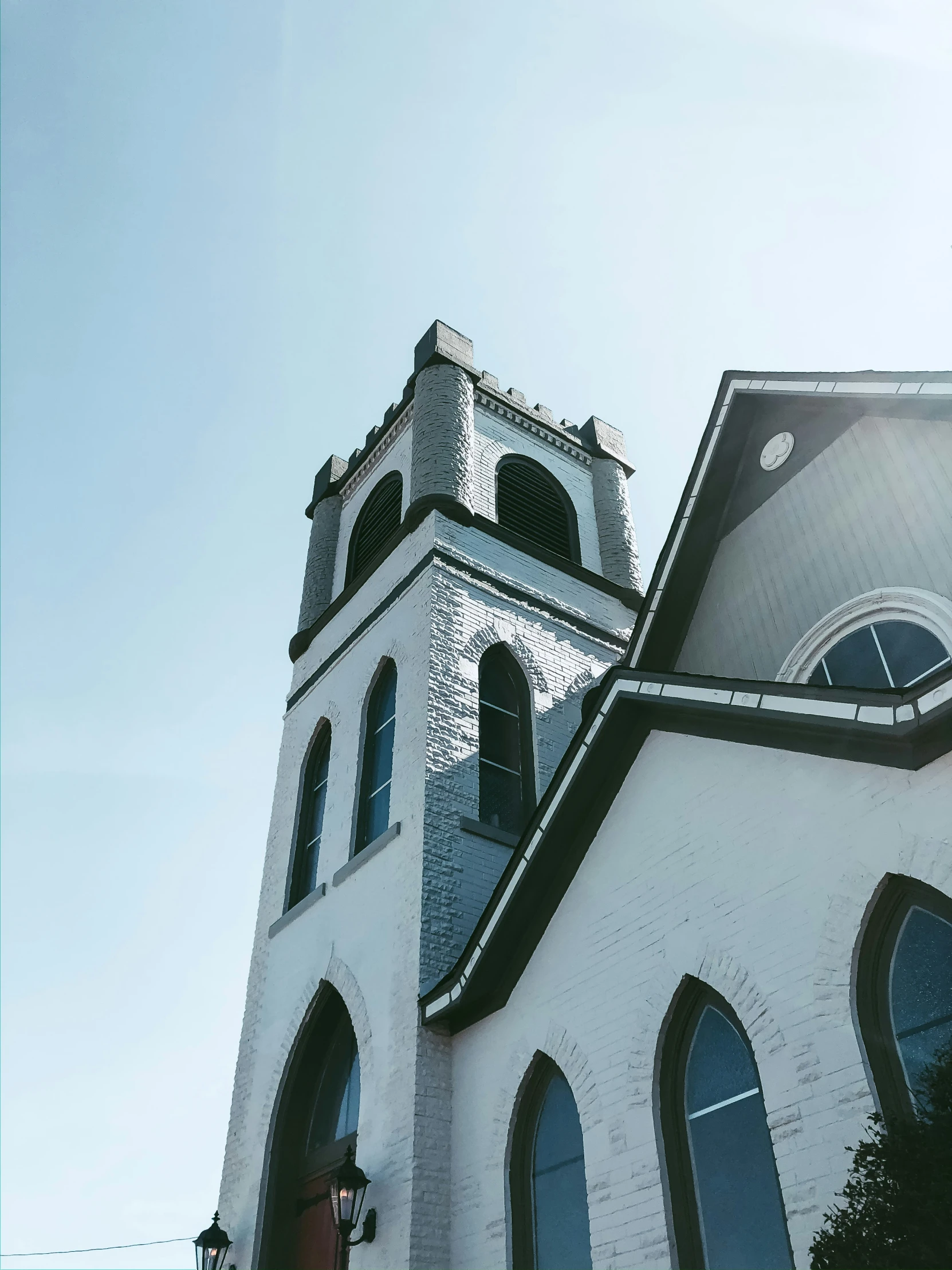 a church with a steeple and clock on the front