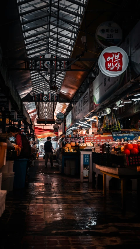 a market with produce displayed for sale with a canopy overhead