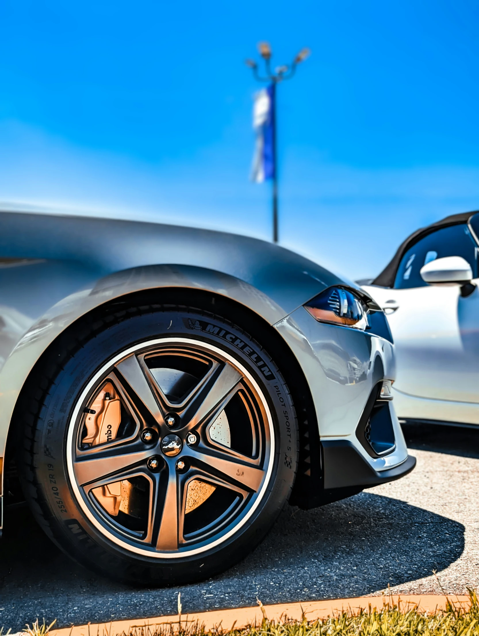 the front wheels of a silver sports car