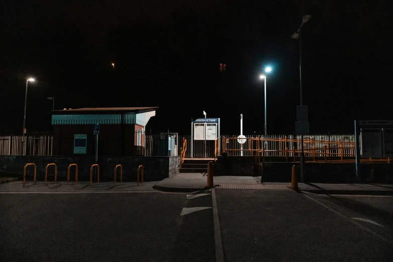 a large parking lot at night with lots of benches around