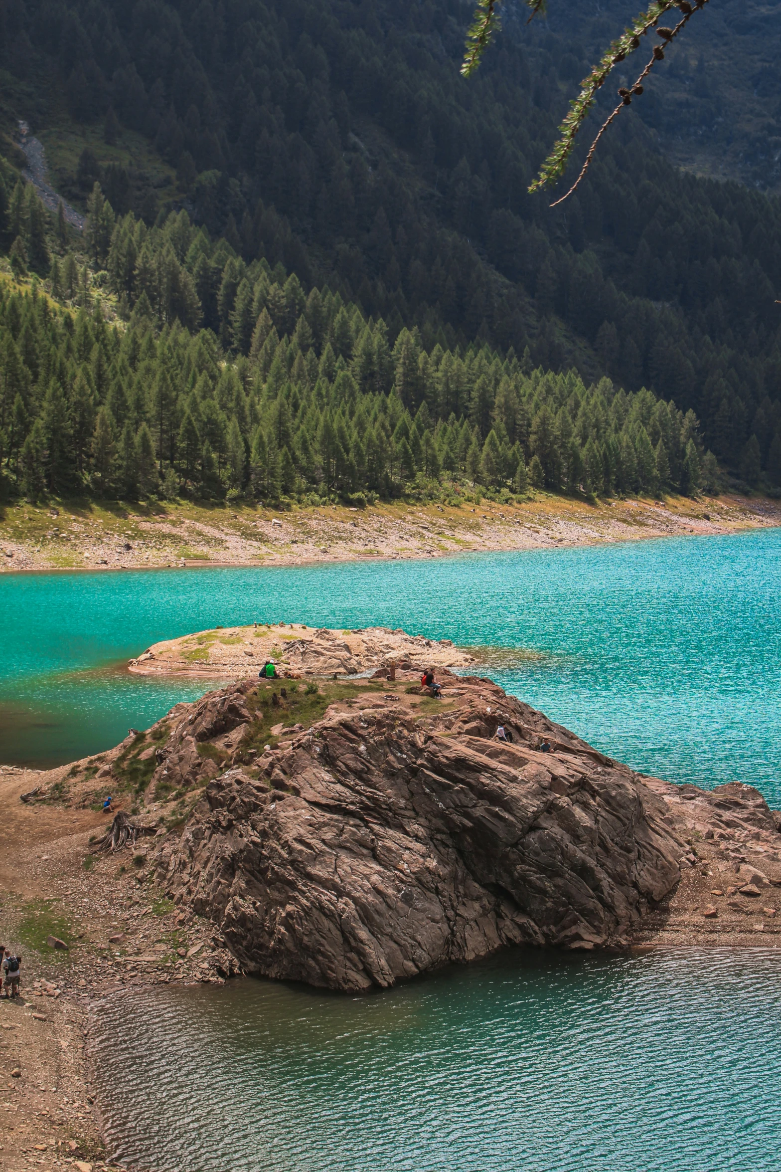 large rock out in the water near a body of water