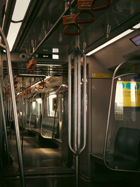 the inside view of a subway car with rails and doors