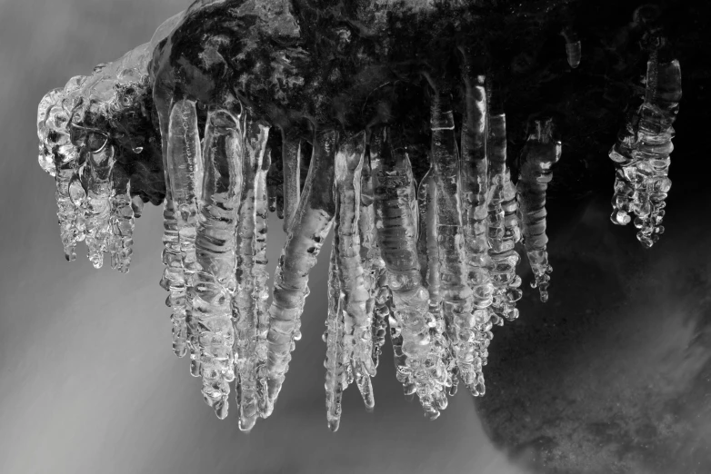 a couple of icicles hanging from a long waterfall